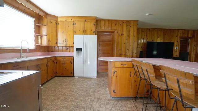 a living room with a fireplace and a walk in closet