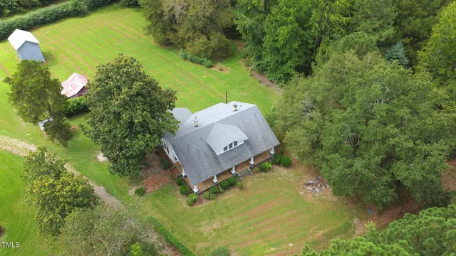an aerial view of a house with a yard basket ball court and outdoor seating