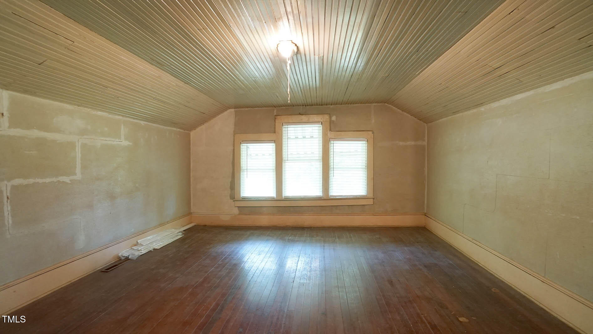 131 King Road Warrenton, NC 27589 - Photo 52 of 67 an empty room with wooden floor and windows