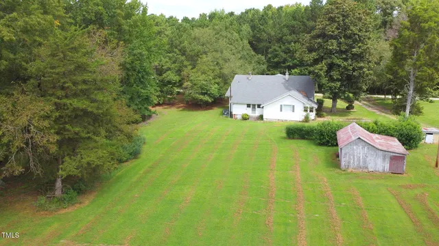 a aerial view of a house with swimming pool and garden