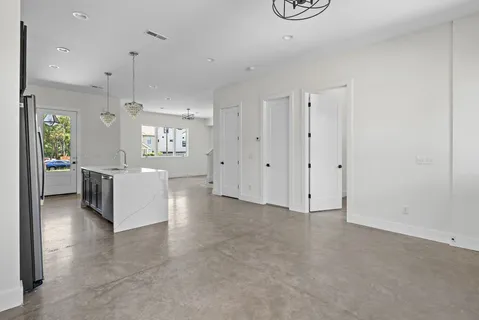 a view of a kitchen with refrigerator and a stove