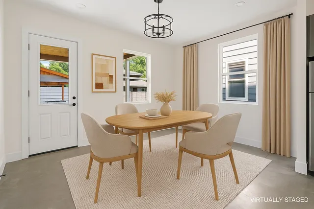 a view of a dining room with furniture and window