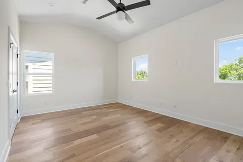 a bedroom with a bed mirror and a window