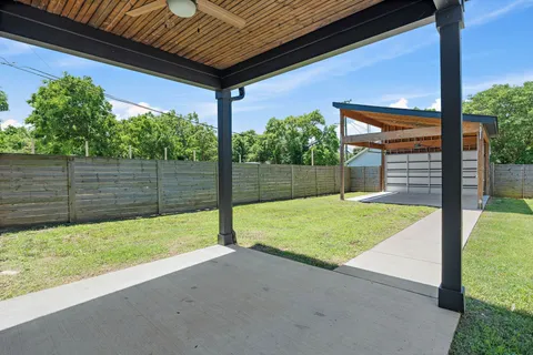 a balcony with furniture and a floor to ceiling window