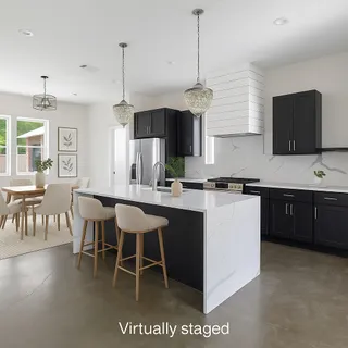 a kitchen with a sink a counter top space and stainless steel appliances