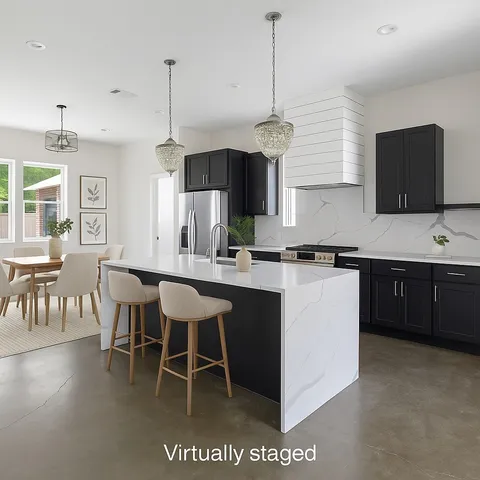 a kitchen with a sink a counter top space and stainless steel appliances