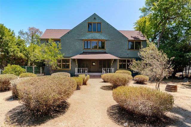 a front view of house with yard covered in snow