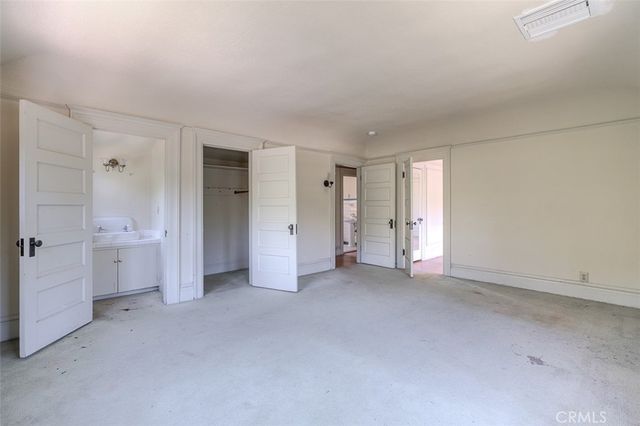 an empty room with a bathroom and a sink