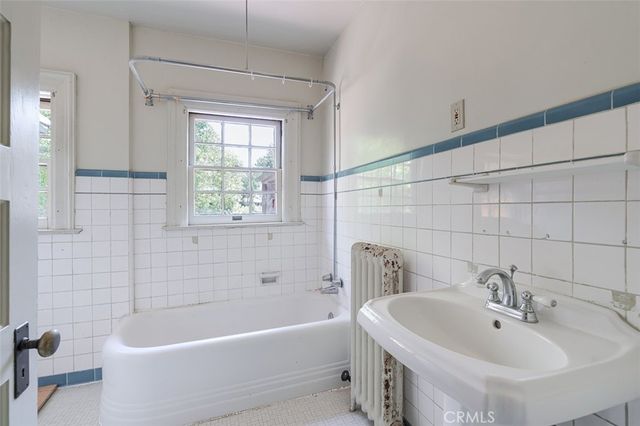a white bath tub sitting next to a white sink