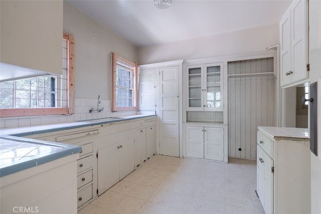 a spacious bathroom with a granite countertop sink and a mirror
