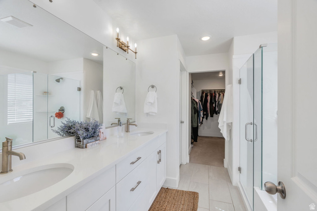 2664 West Maple Street Mapleton, UT 84664 - Photo 6 of 49 Bathroom featuring a dual vanity with undermount sinks and brushed nickel faucets, a frameless glass-enclosed shower, a large wall-mounted mirror, and recessed lighting