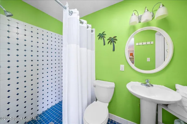 a bathroom with a sink mirror vanity and toilet