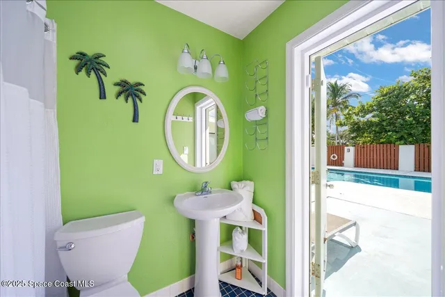 a bathroom with a sink mirror and toilet