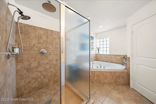 a bedroom with a bed and a tv on the wall