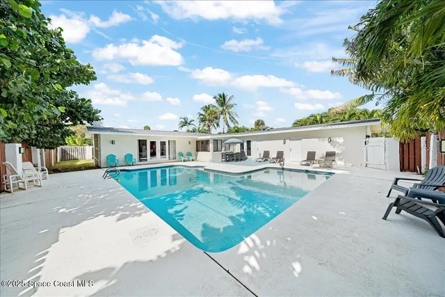 a front view of house with yard and trees