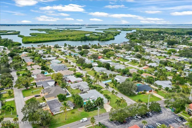 a view of a dry yard with wooden fence