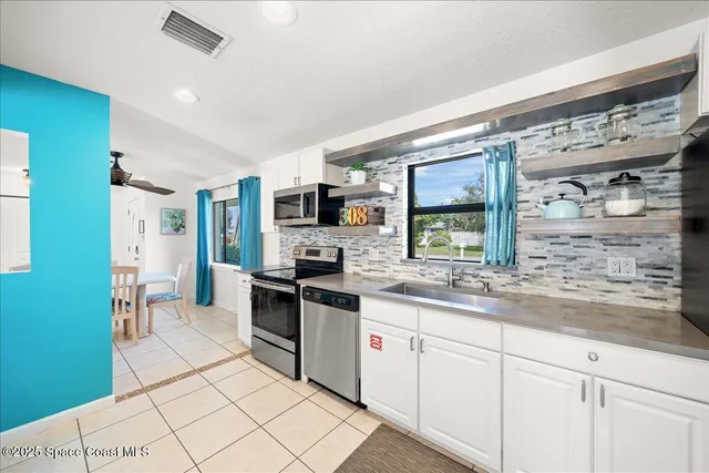 a kitchen with stainless steel appliances granite countertop a sink and cabinets