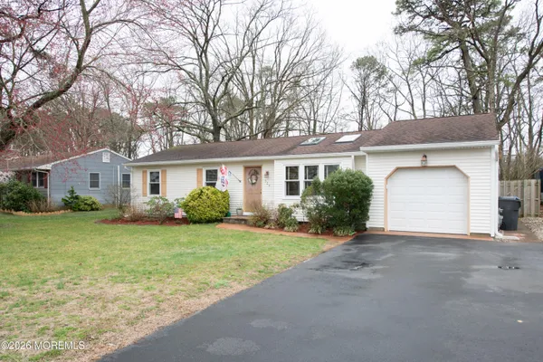 a front view of a house with a garden and yard