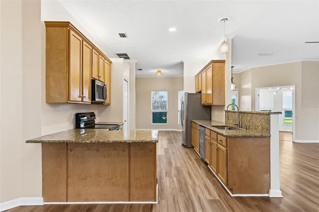 a kitchen with granite countertop a stove and a cabinet