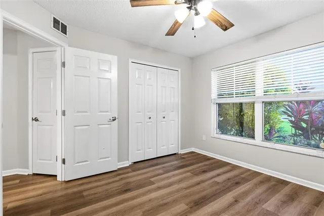 a spacious bathroom with a tub sink and mirror