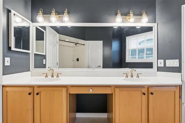 a kitchen with stainless steel appliances granite countertop a sink a stove and a wooden floors