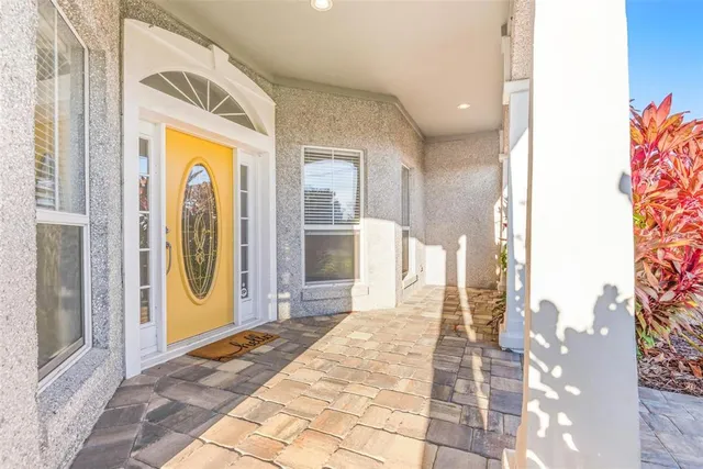 a view of an empty room with wooden floor fireplace and a window