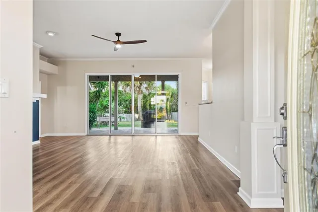 wooden floor fireplace and windows in an empty room