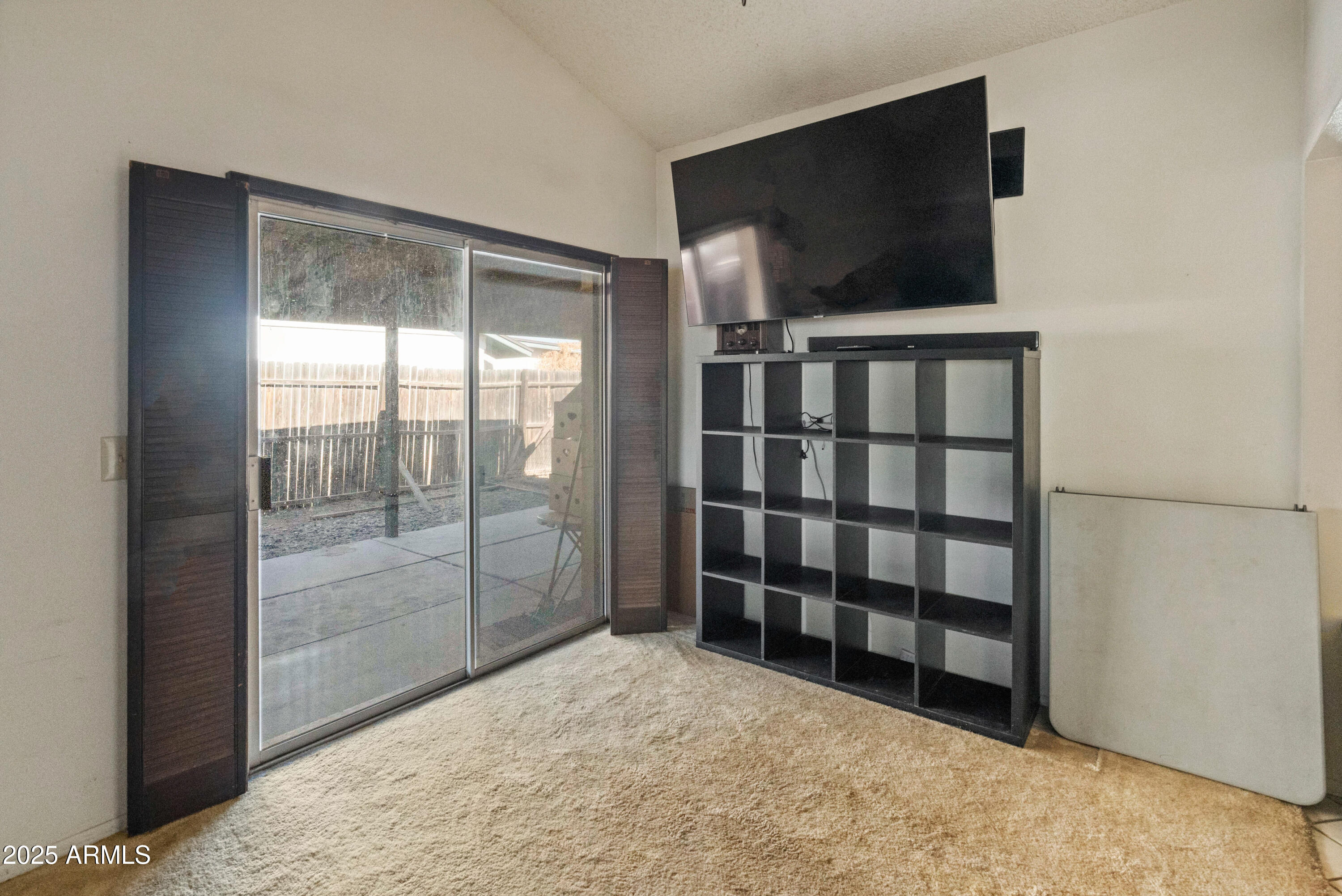 5506 West Hatcher Road Glendale, AZ 85302 - Photo 11 of 23 a view of a livingroom with wooden floor and a flat screen tv
