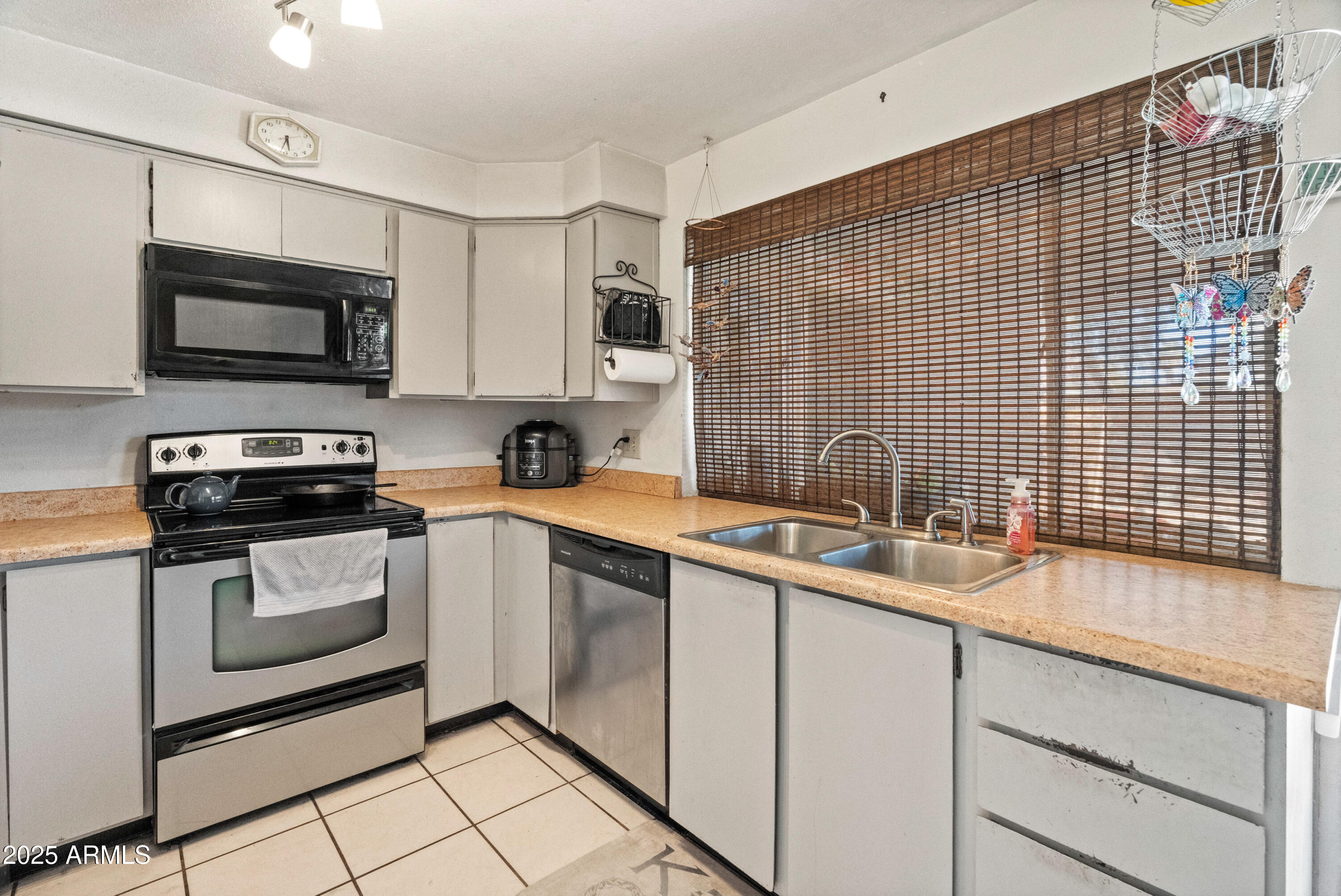 5506 West Hatcher Road Glendale, AZ 85302 - Photo 6 of 23 a kitchen with a sink cabinets and stainless steel appliances