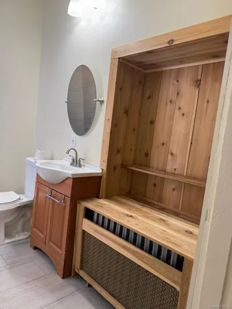 a bathroom with a toilet sink and mirror