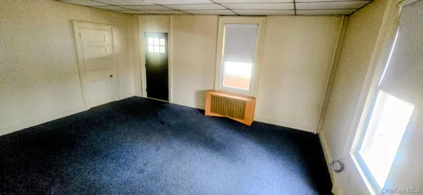 a view of an empty room and wooden floor