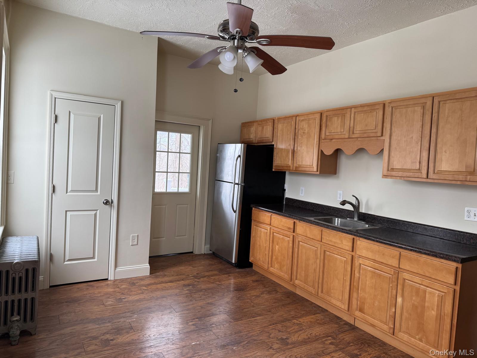 41 Clove Road Salisbury Mills, NY 12577 - Photo 9 of 24 a kitchen with stainless steel appliances granite countertop a refrigerator a sink dishwasher a stove and white countertops with wooden floor