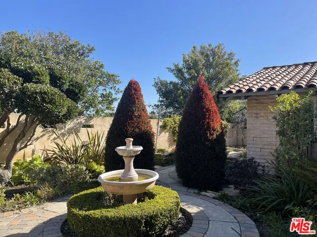 a view of a fountain in the backyard of house