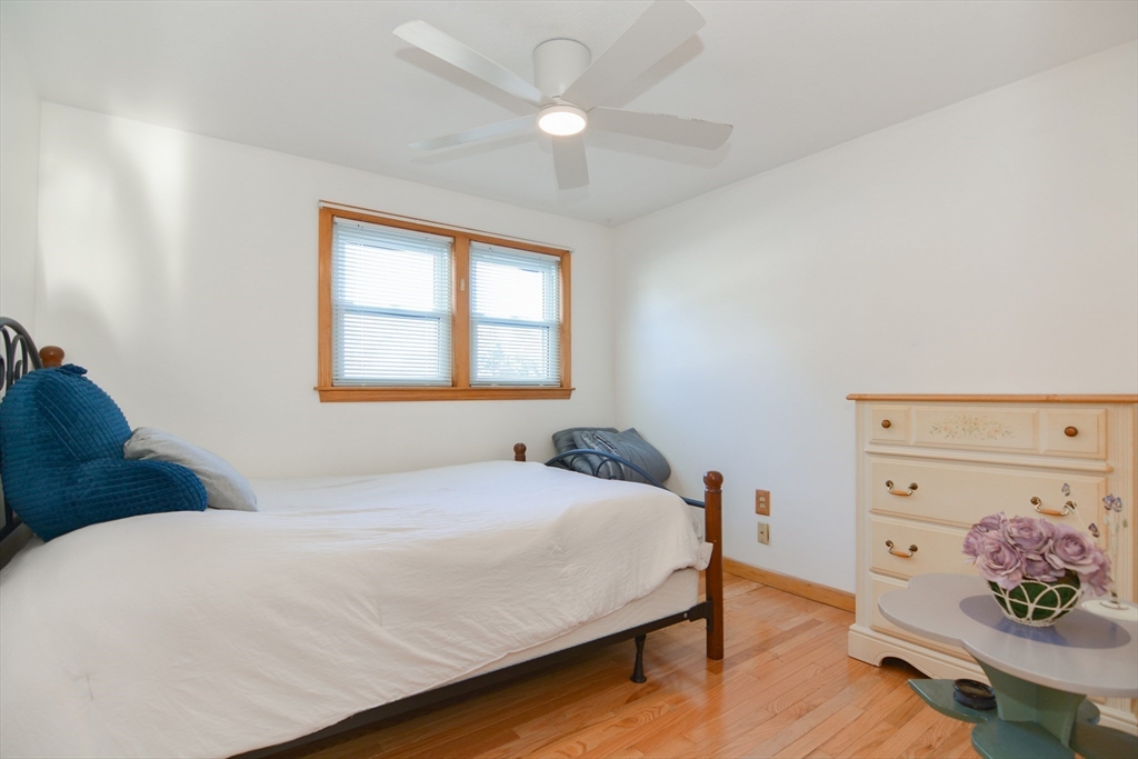 51 Heritage Road Billerica, MA 01821 - Photo 12 of 32 a bedroom with a bed and wooden floor