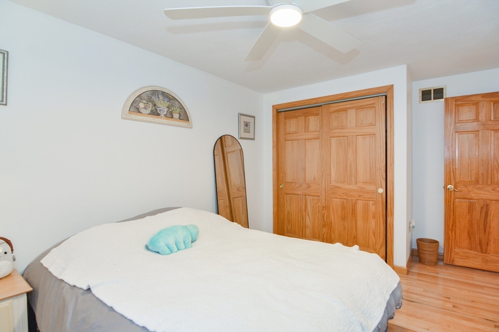 51 Heritage Road Billerica, MA 01821 - Photo 14 of 32 a bedroom with a bed and a dresser