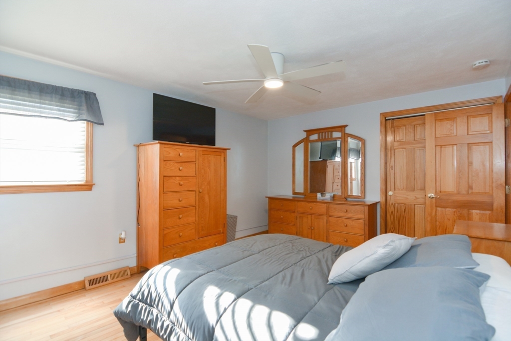 51 Heritage Road Billerica, MA 01821 - Photo 17 of 32 a bedroom with a bed and dresser with mirror