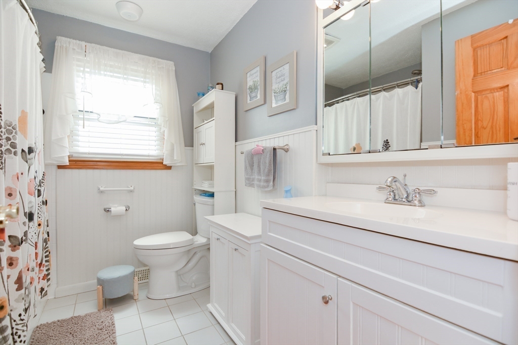 51 Heritage Road Billerica, MA 01821 - Photo 18 of 32 a bathroom with a granite countertop sink mirror vanity and toilet