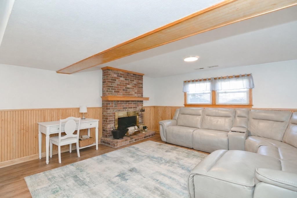 51 Heritage Road Billerica, MA 01821 - Photo 19 of 32 a living room with furniture and a fireplace