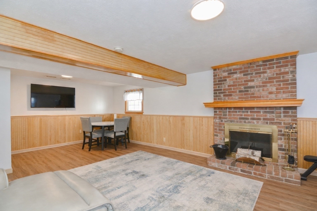51 Heritage Road Billerica, MA 01821 - Photo 20 of 32 a living room with furniture and a fireplace