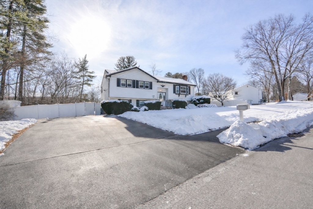 51 Heritage Road Billerica, MA 01821 - Photo 2 of 32 a front view of a house with a yard covered in snow