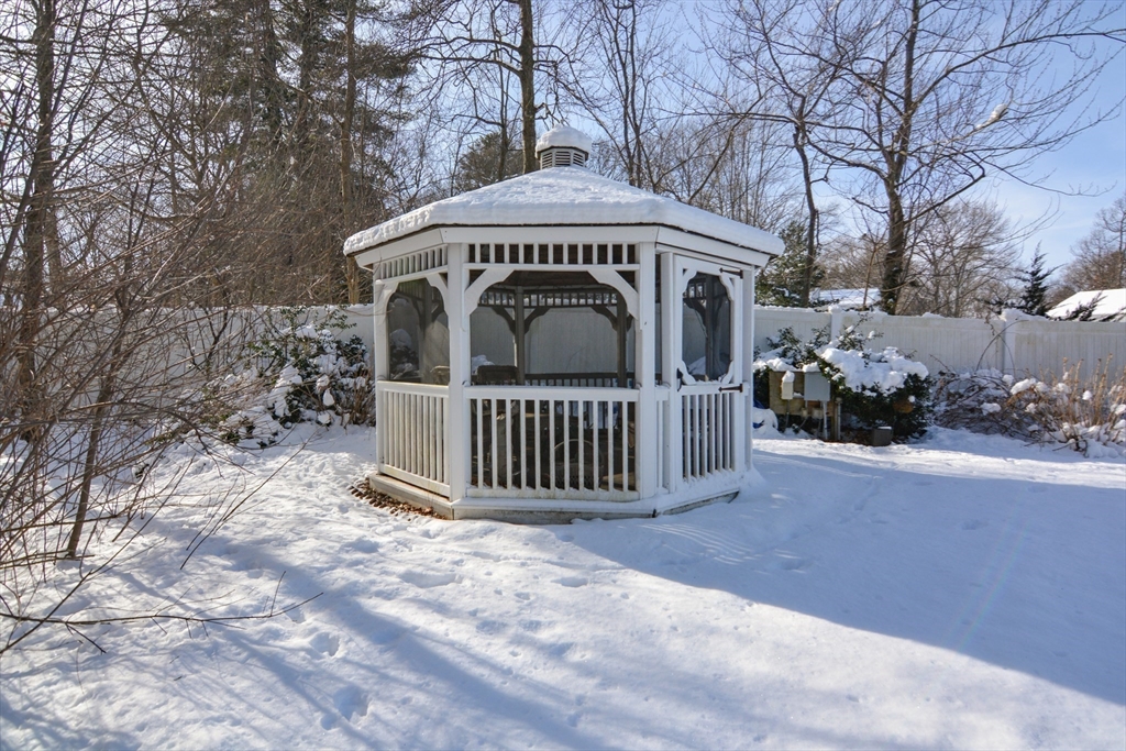 51 Heritage Road Billerica, MA 01821 - Photo 24 of 32 a view of a wooden house with large trees and a small yard