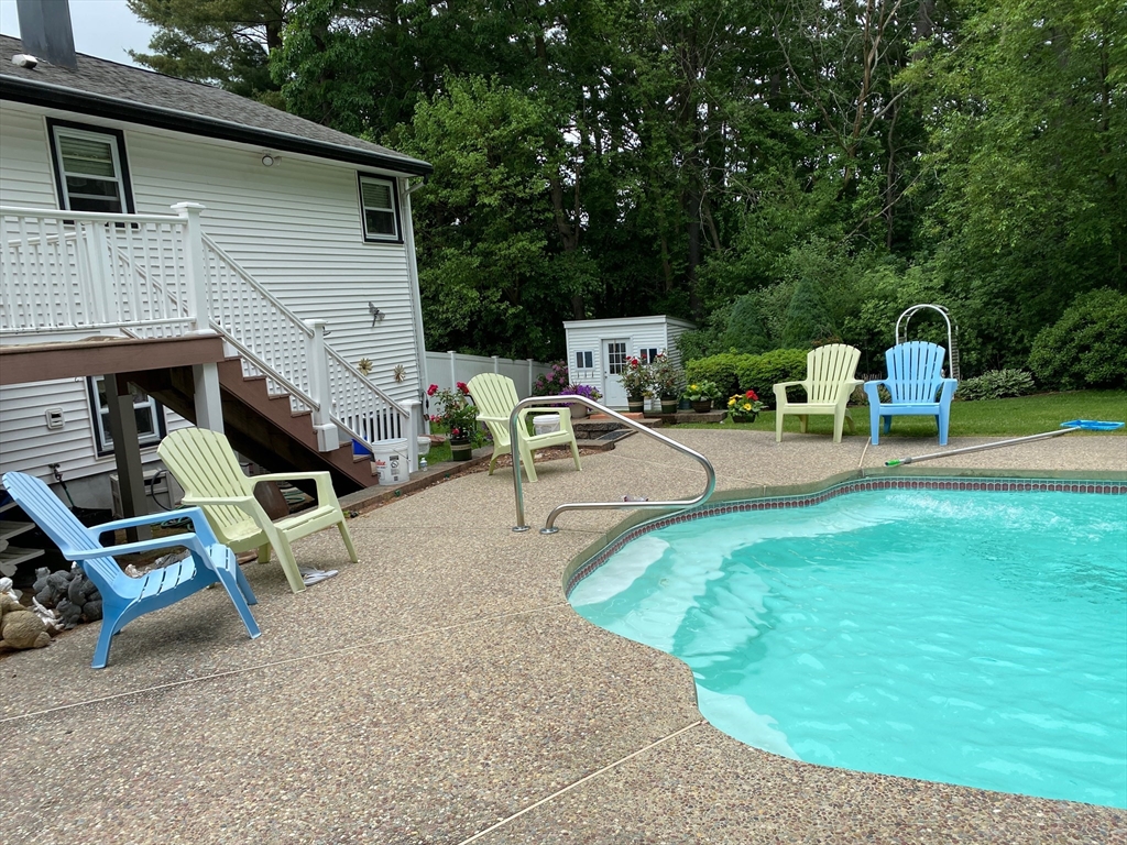 51 Heritage Road Billerica, MA 01821 - Photo 29 of 32 a view of a backyard with chairs and a fire pit