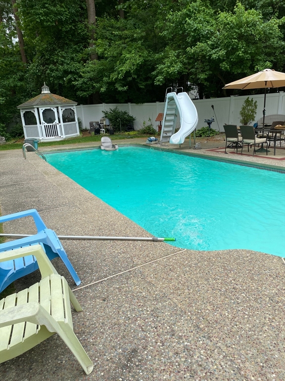 51 Heritage Road Billerica, MA 01821 - Photo 31 of 32 a house with swimming pool in front of it