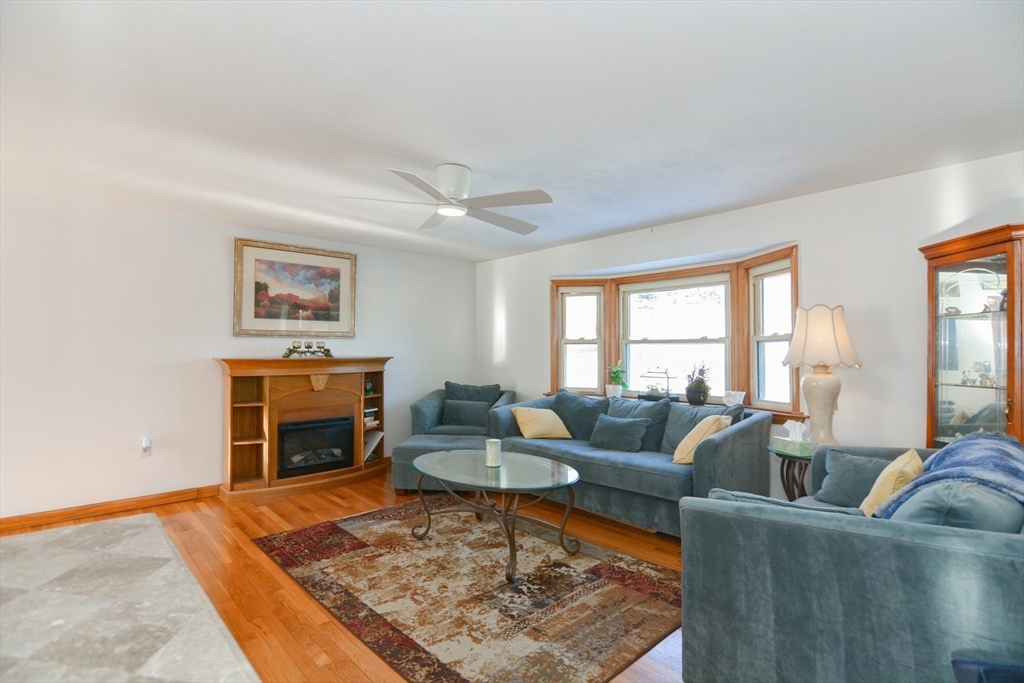 51 Heritage Road Billerica, MA 01821 - Photo 4 of 32 a living room with furniture and a fireplace