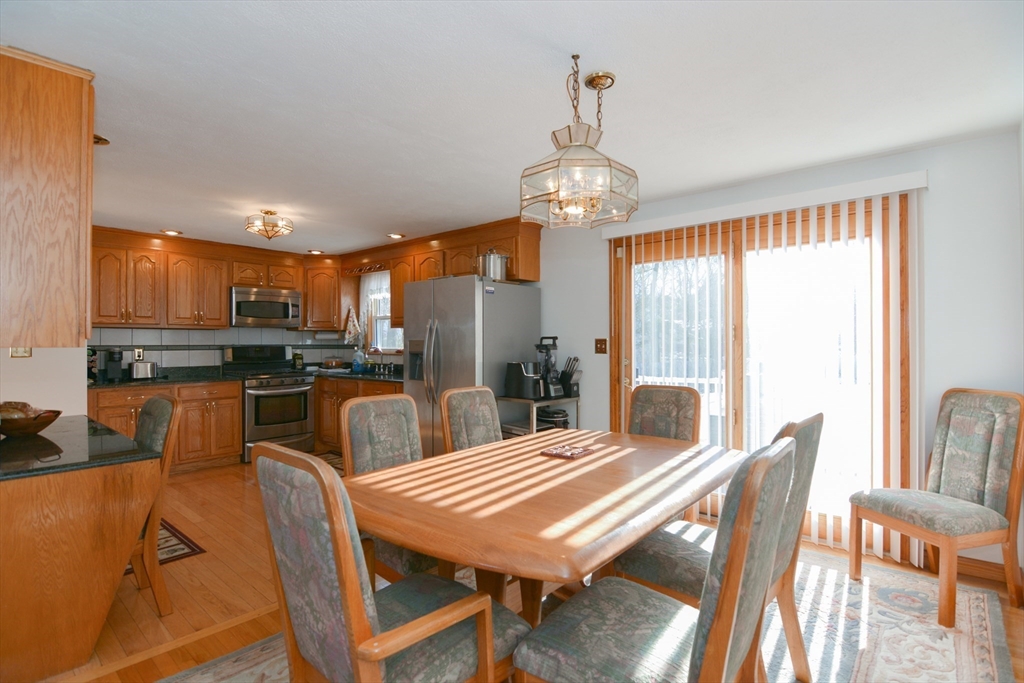 51 Heritage Road Billerica, MA 01821 - Photo 8 of 32 a view of a dining room with furniture wooden floor and chandelier