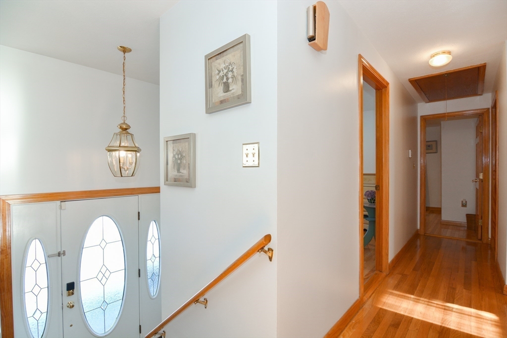 51 Heritage Road Billerica, MA 01821 - Photo 10 of 32 a view of a hallway with entryway wooden floor and front door