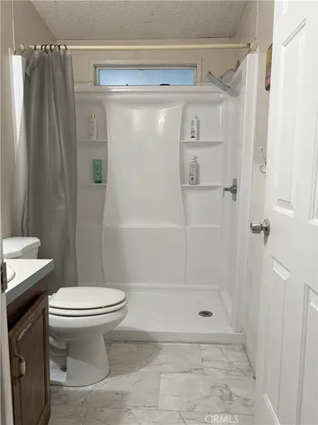 a bathroom with a shower and a toilet