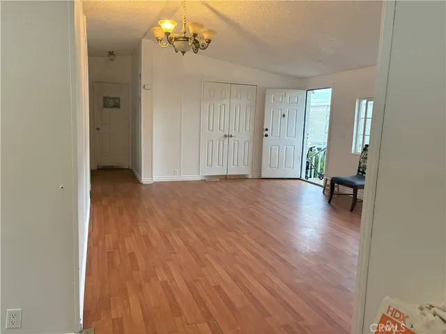 a view of a livingroom with a hardwood floor and a ceiling fan