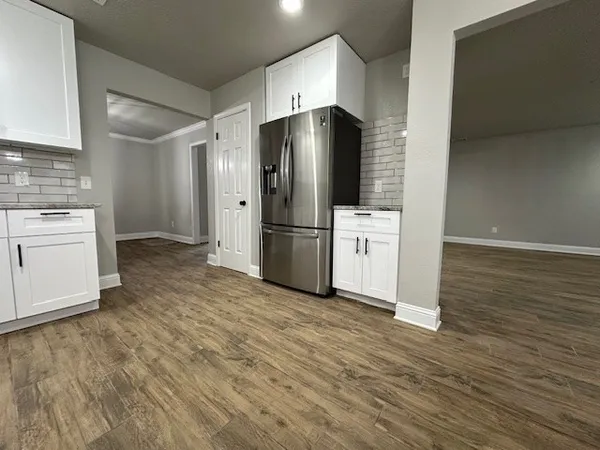 a kitchen with stainless steel appliances a refrigerator and a stove top oven