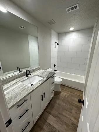 a bathroom with a double vanity sink and mirror with shower